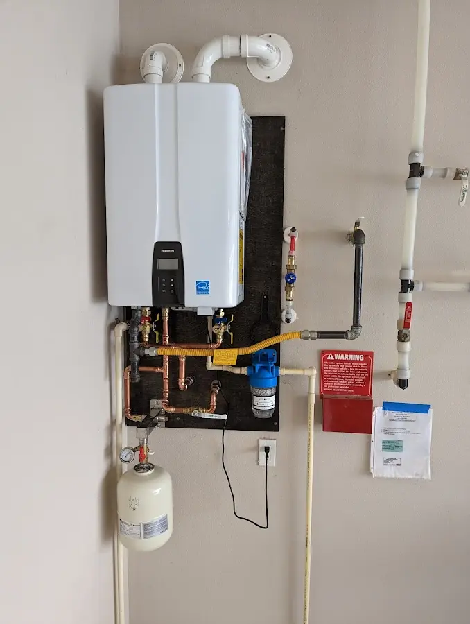 Professional plumber installing copper piping in a Country Club home